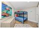 Charming bedroom with a bunk bed, colorful rug, and a modern wood cabinet at 399 2Nd St # 718, Indian Rocks Beach, FL 33785