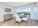 Elegant dining area with a round table, white chairs, and breathtaking water views at 399 2Nd St # 718, Indian Rocks Beach, FL 33785