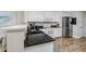 Modern kitchen with granite countertop and stainless steel fridge at 399 2Nd St # 718, Indian Rocks Beach, FL 33785