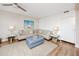 Spacious living room features a large sectional sofa, comfortable ottoman, and hardwood floors at 399 2Nd St # 718, Indian Rocks Beach, FL 33785