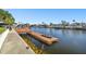 Private dock with a boat lift and kayak, offering direct water access at 5040 Porpoise Pl, New Port Richey, FL 34652