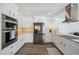 Bright kitchen with stainless steel appliances and white cabinetry at 5040 Porpoise Pl, New Port Richey, FL 34652