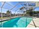 This beautiful screened pool overlooks the canal, perfect for relaxing and enjoying the Florida sunshine at 5040 Porpoise Pl, New Port Richey, FL 34652