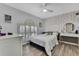 Bright bedroom with wood floors, pineapple wallpaper, and window shutters at 5524 Avenue Du Soleil, Lutz, FL 33558