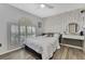 Light and airy bedroom featuring wood floors and a pineapple accent wall at 5524 Avenue Du Soleil, Lutz, FL 33558