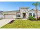 Two-story house with neutral siding, stone accents, and a two-car garage at 5911 Jaudon Ave, Wesley Chapel, FL 33545