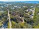 Aerial view showing home, lush landscaping, and waterfront access at 775 Pennsylvania Ave, Palm Harbor, FL 34683
