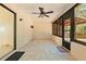 Relaxing screened porch with tile flooring and ceiling fan at 8069 Pagoda Dr, Spring Hill, FL 34606