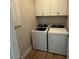 Laundry room with washer and dryer and white cabinets at 10458 Abaco Falls Dr, Englewood, FL 34223