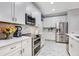 Modern kitchen with white cabinets, stainless steel appliances, and quartz countertops at 10828 Quickwater Ct, Riverview, FL 33569