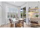 Kitchen dining area with white table and four chairs, featuring a view to backyard at 14433 Mirabelle Vista Cir, Tampa, FL 33626