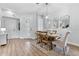 Dining area with light wood table and chairs, wood floors, and white walls at 14433 Mirabelle Vista Cir, Tampa, FL 33626