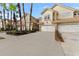 Wide view of townhome community with tan two-story homes and palm trees at 14433 Mirabelle Vista Cir, Tampa, FL 33626