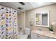 Clean bathroom with a shower/tub combo and granite vanity at 147 Bluff View Dr # 204, Belleair Bluffs, FL 33770