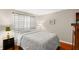 Cozy bedroom with striped curtains and a comfortable bed at 147 Bluff View Dr # 204, Belleair Bluffs, FL 33770