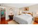 Main bedroom with king-size bed and hardwood floors at 147 Bluff View Dr # 204, Belleair Bluffs, FL 33770