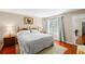 Main bedroom with king-size bed and hardwood floors at 147 Bluff View Dr # 204, Belleair Bluffs, FL 33770