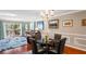 Dining area with glass table and leather chairs, adjacent to living room at 147 Bluff View Dr # 204, Belleair Bluffs, FL 33770