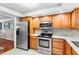 Kitchen with stainless steel appliances and granite countertops at 147 Bluff View Dr # 204, Belleair Bluffs, FL 33770