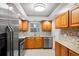 Updated kitchen with stainless steel appliances and light wood cabinets at 147 Bluff View Dr # 204, Belleair Bluffs, FL 33770