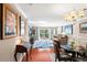 Bright living room with hardwood floors, featuring a dining area and balcony access at 147 Bluff View Dr # 204, Belleair Bluffs, FL 33770