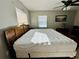 King-size bed in well-lit bedroom with two windows at 1510 Allegheny Dr, Sun City Center, FL 33573