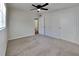 Spacious bedroom with neutral carpeting and ceiling fan at 1625 St Catherine W Dr, Dunedin, FL 34698