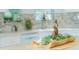 Kitchen counter detail featuring a decorative wooden bowl with plants and seashells at 18675 Us Highway 19 N # 389, Clearwater, FL 33764