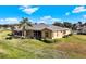 Aerial view of tan house with screened patio and lush landscaping at 2493 Kensington Greens Dr # 2493, Sun City Center, FL 33573