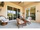 Spacious covered patio with glass doors and comfortable wicker furniture at 2493 Kensington Greens Dr # 2493, Sun City Center, FL 33573