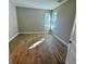 Well-lit bedroom with light gray walls and wood-look tile floors at 25989 Bimini Sands Ct, Englewood, FL 34223