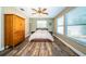 Bright bedroom with queen-size bed and wood-look floors at 29919 69Th N St, Clearwater, FL 33761