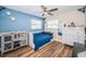 Bedroom with light wood floors and blue accent wall at 29919 69Th N St, Clearwater, FL 33761