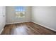 Bright bedroom with wood-look floors and a large window at 4160 Little Gap Loop, Ellenton, FL 34222