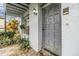 Gray front door with a covered entryway and landscaping at 4453 Vieux Carre Cir, Tampa, FL 33613