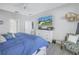 Spacious bedroom with large bed, dresser, and comfortable armchair at 4889 Edgewater Ln, Oldsmar, FL 34677