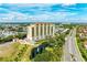 High-rise condo building with pool and fountain, next to a road at 501 Haben Blvd # 806, Palmetto, FL 34221