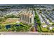 Birds-eye view of building featuring a swimming pool, pond, and lush greenery, offering a serene living environment at 501 Haben Blvd # 806, Palmetto, FL 34221
