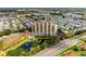 High-rise residential building with pool and pond, surrounded by greenery at 501 Haben Blvd # 806, Palmetto, FL 34221