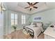 This charming bedroom is painted with a cool mint color and features tray ceilings and shuttered windows at 501 Haben Blvd # 806, Palmetto, FL 34221