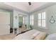 This comfortable bedroom features cool mint walls and shuttered windows for privacy and light control at 501 Haben Blvd # 806, Palmetto, FL 34221