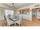 Elegant dining room with seating for eight, chandelier, and kitchen views at 501 Haben Blvd # 806, Palmetto, FL 34221