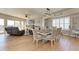 Elegant dining area featuring a large window, stylish lighting fixture, and beautiful hardwood floors at 501 Haben Blvd # 806, Palmetto, FL 34221