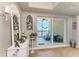 Entryway with decorative accents leading to a large sliding glass door with a view of a balcony at 501 Haben Blvd # 806, Palmetto, FL 34221
