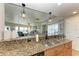 Modern kitchen featuring stainless steel appliances, granite counters, and an open floor plan at 501 Haben Blvd # 806, Palmetto, FL 34221