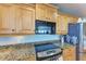Updated kitchen with granite countertops, stainless steel appliances, and wooden cabinetry at 501 Haben Blvd # 806, Palmetto, FL 34221