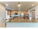 Beautiful kitchen with stainless steel appliances, granite countertops, and chandelier lighting at 501 Haben Blvd # 806, Palmetto, FL 34221