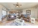Open-concept living room with leather seating, decorative rug, and views into the kitchen at 501 Haben Blvd # 806, Palmetto, FL 34221
