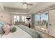 A view of the main bedroom featuring a private balcony, light-colored walls, and shuttered windows at 501 Haben Blvd # 806, Palmetto, FL 34221