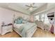 Comfortable main bedroom features an upholstered bed frame, light wood floors, and a ceiling fan with light fixture at 501 Haben Blvd # 806, Palmetto, FL 34221